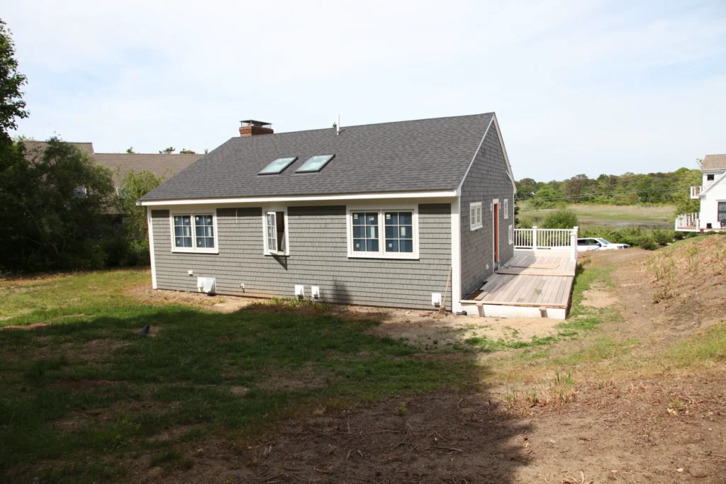 Gray-shingled Cape home and deck overlooking marshland in Dennis, MA