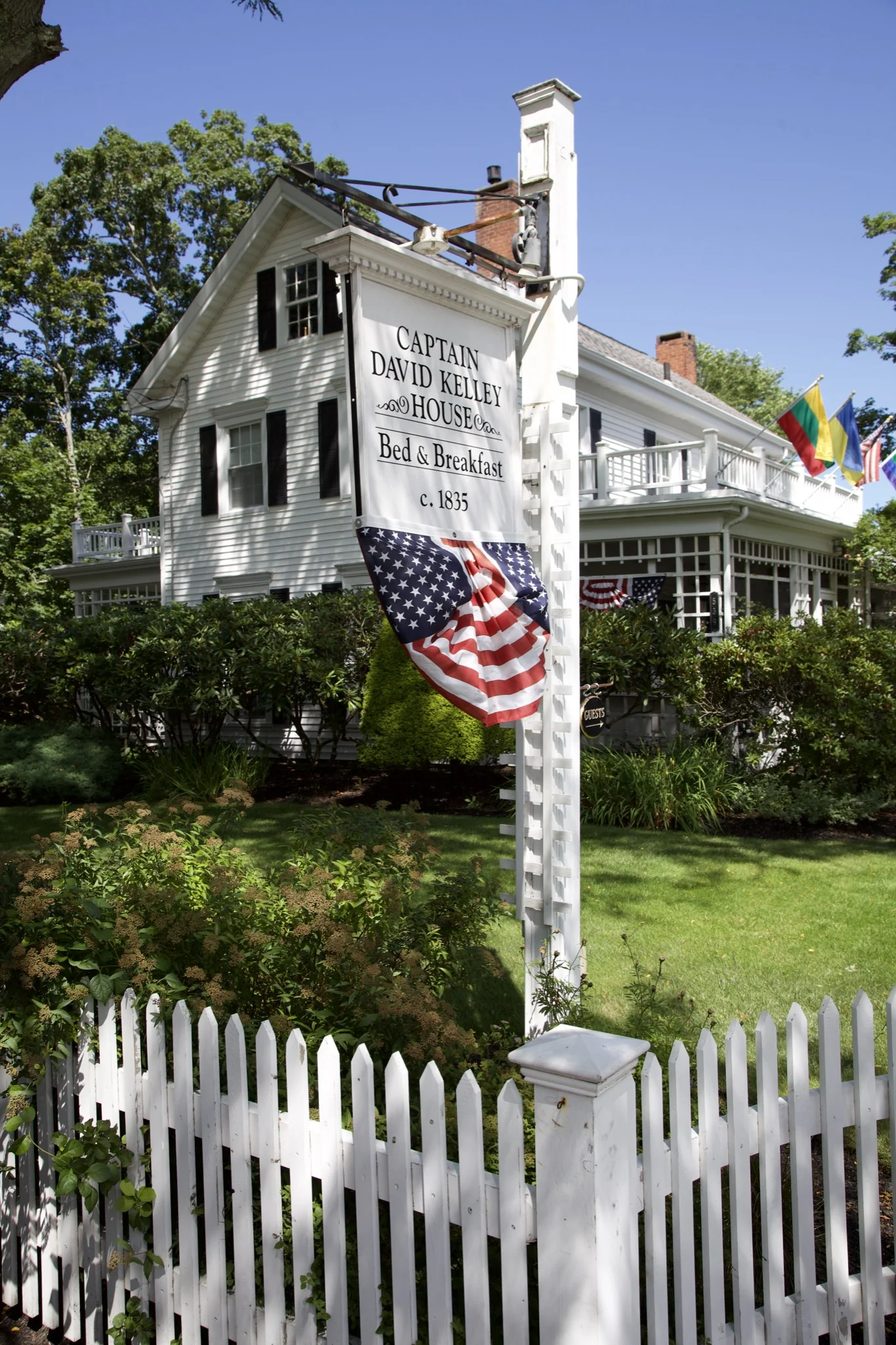 White picket fence and flagpole outside a historic Centerville house, Barnstable