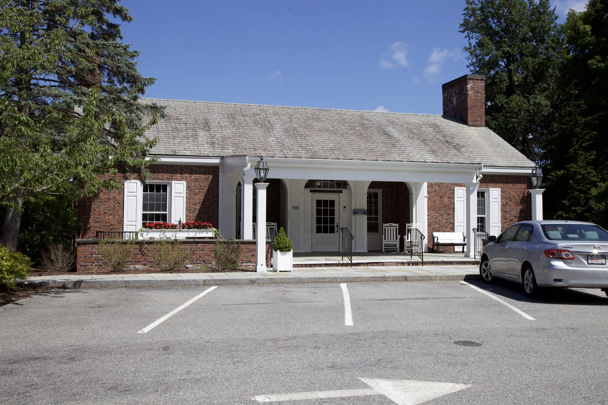 Brick village building with white columns and shuttered windows in Centerville, Barnstable