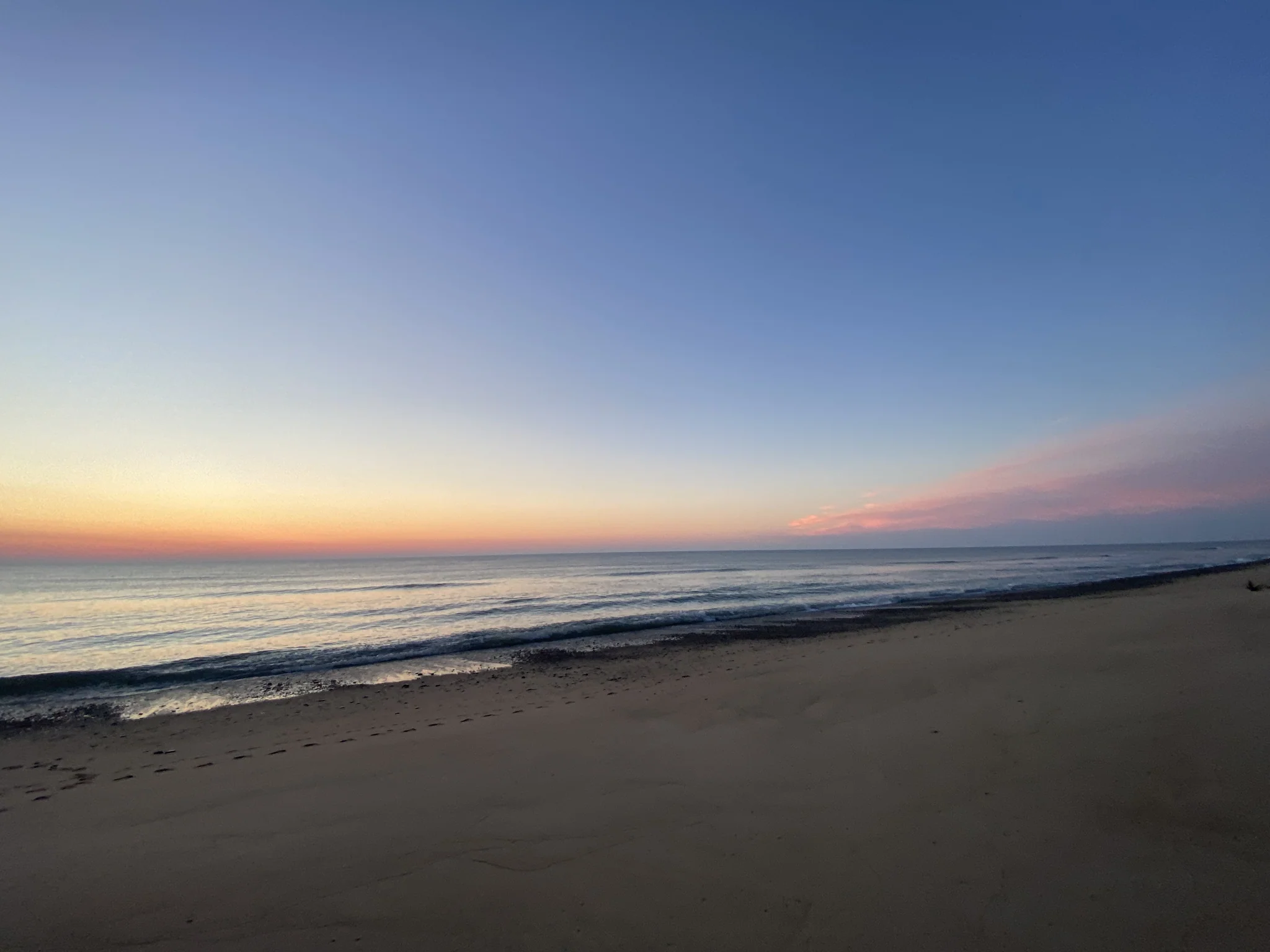 Empty Eastham beach curving into the distance at first light
