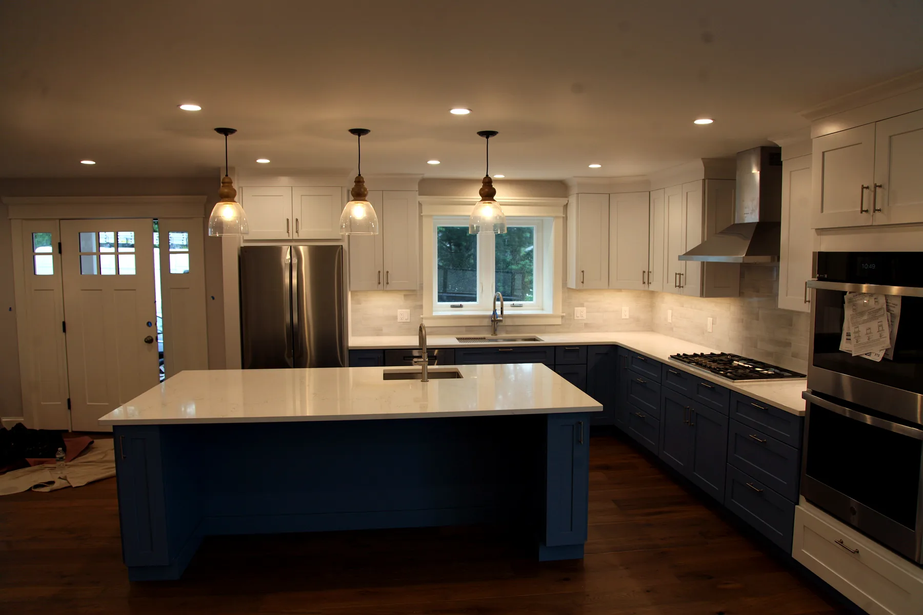 Renovated Cape Cod kitchen with an island, opened sightlines and updated finishes