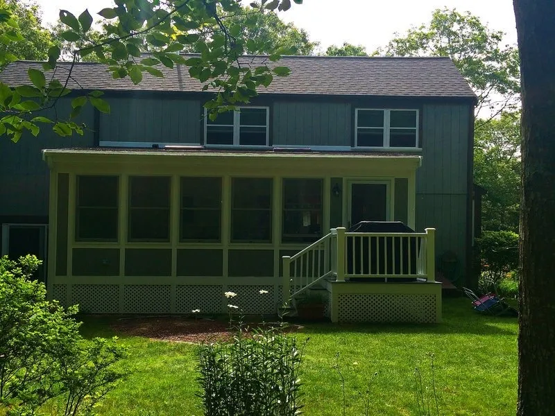 Home addition design on Cape Cod — a sunroom addition integrated into the existing home