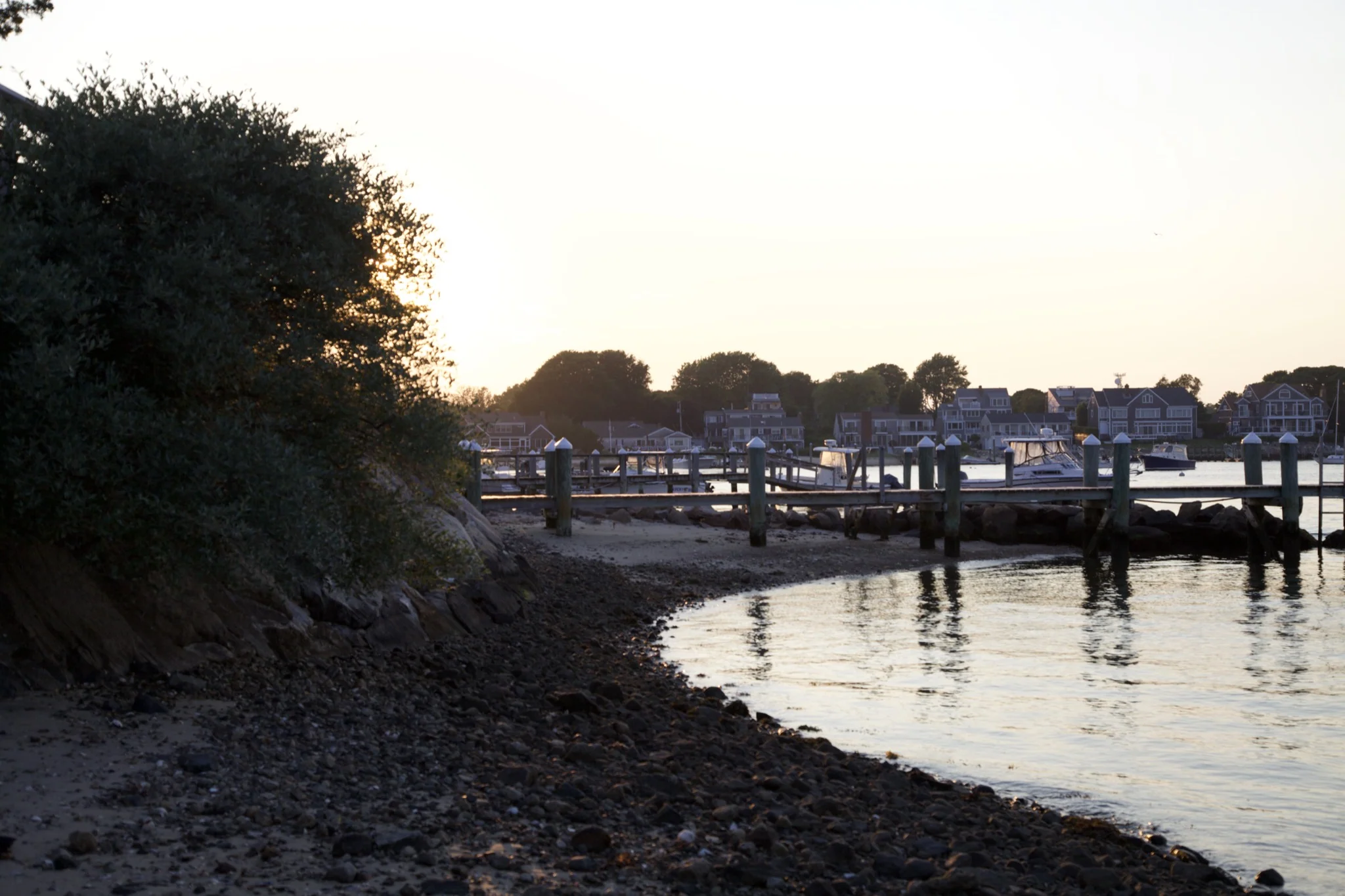 Wooden pilings and dock at dusk on Hyannis Port harbor