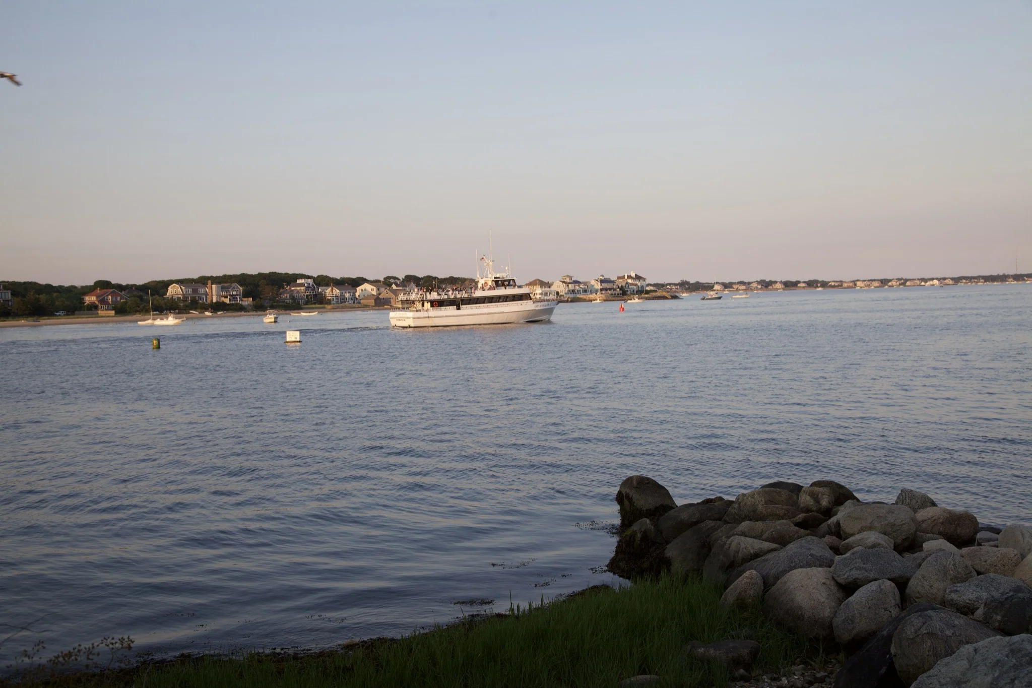 Rock revetment and moored boats in the harbor at Hyannis Port