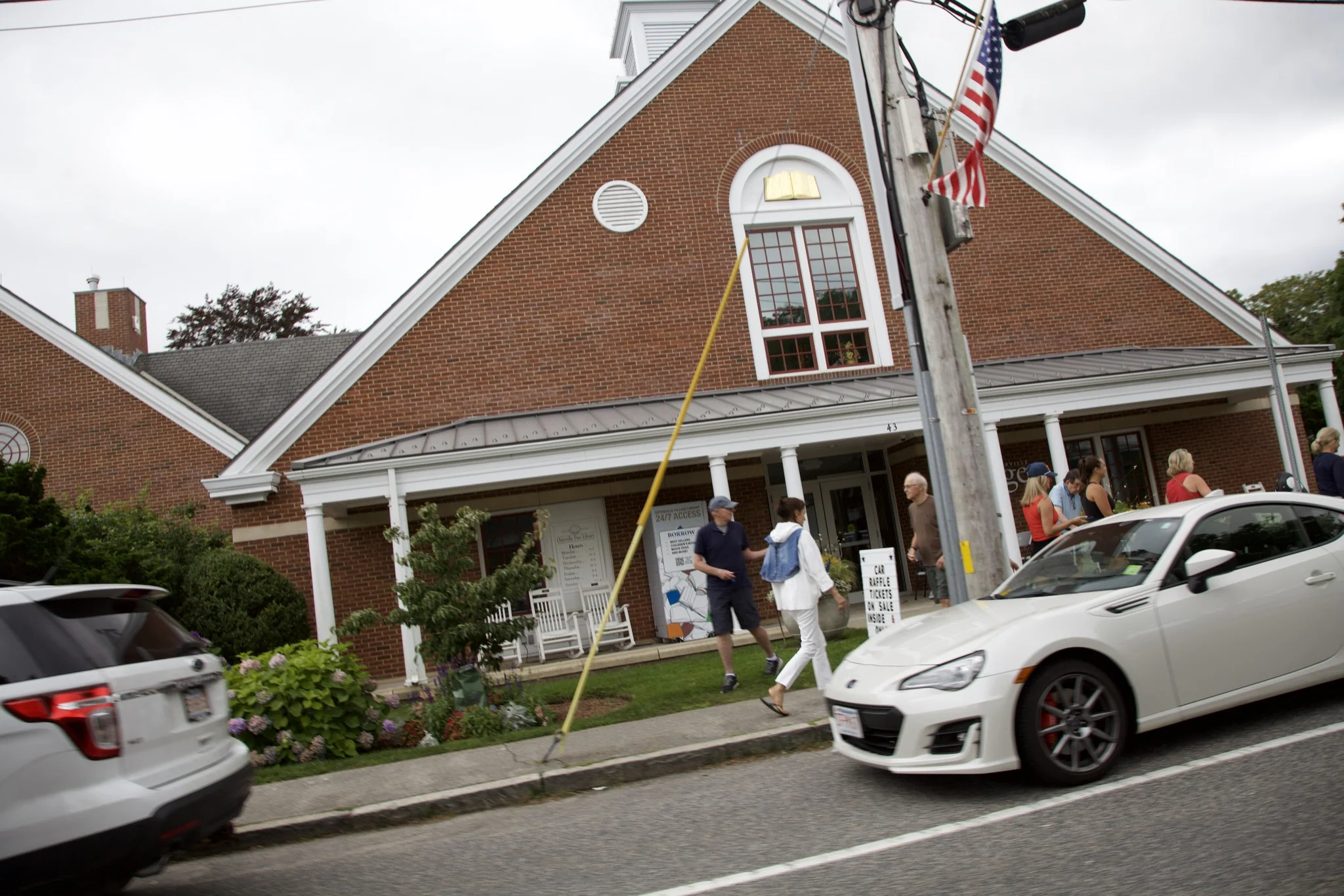 Brick storefront with flag on Main Street in Osterville village, Barnstable