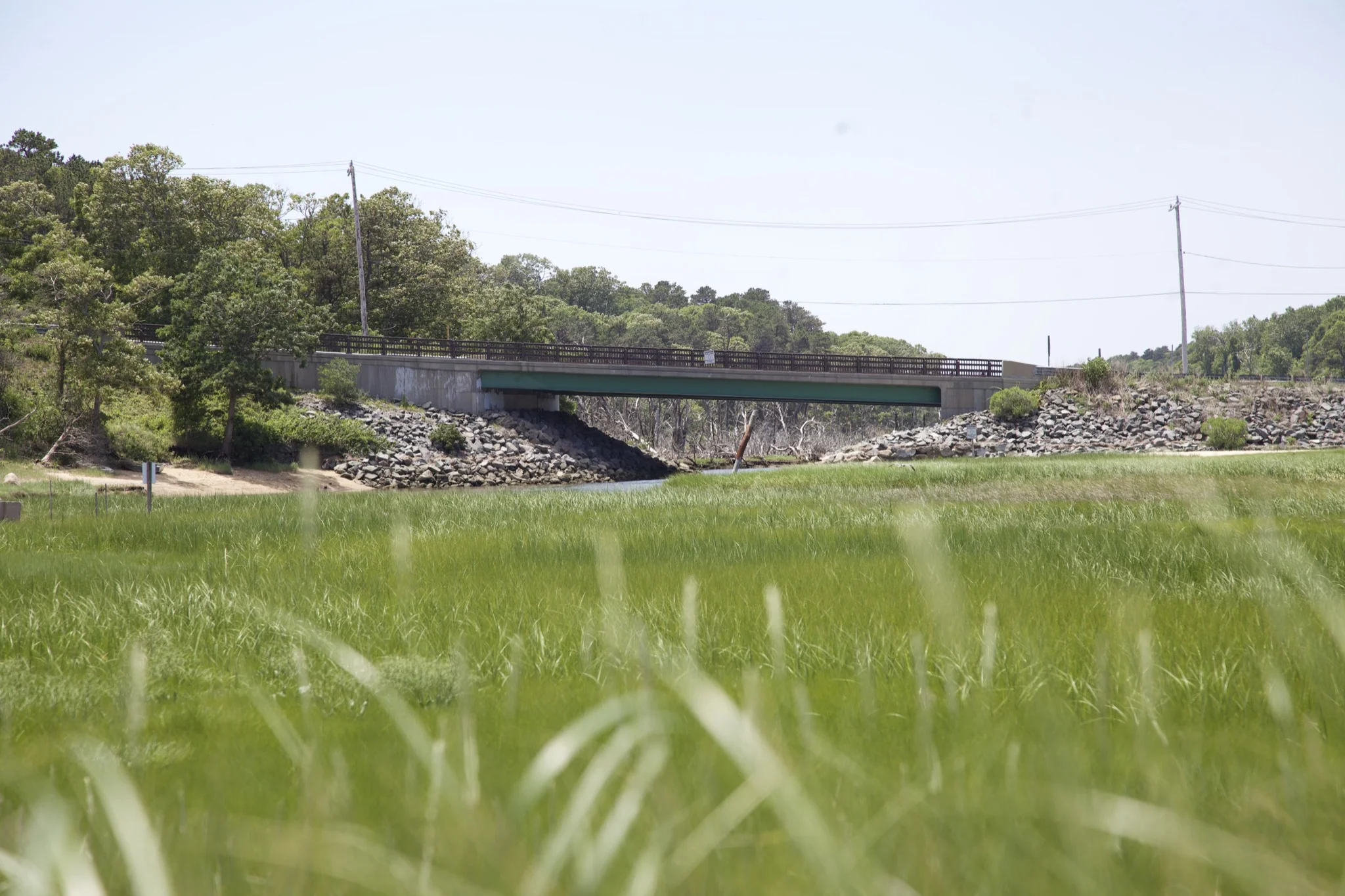 Steel bridge crossing the tidal channel above the marsh in Chatham
