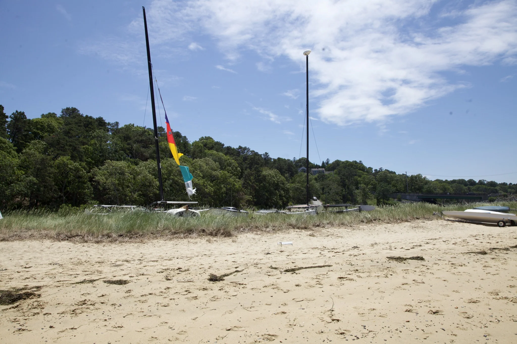 Catamaran drawn up on the sand at the edge of the Chatham cove