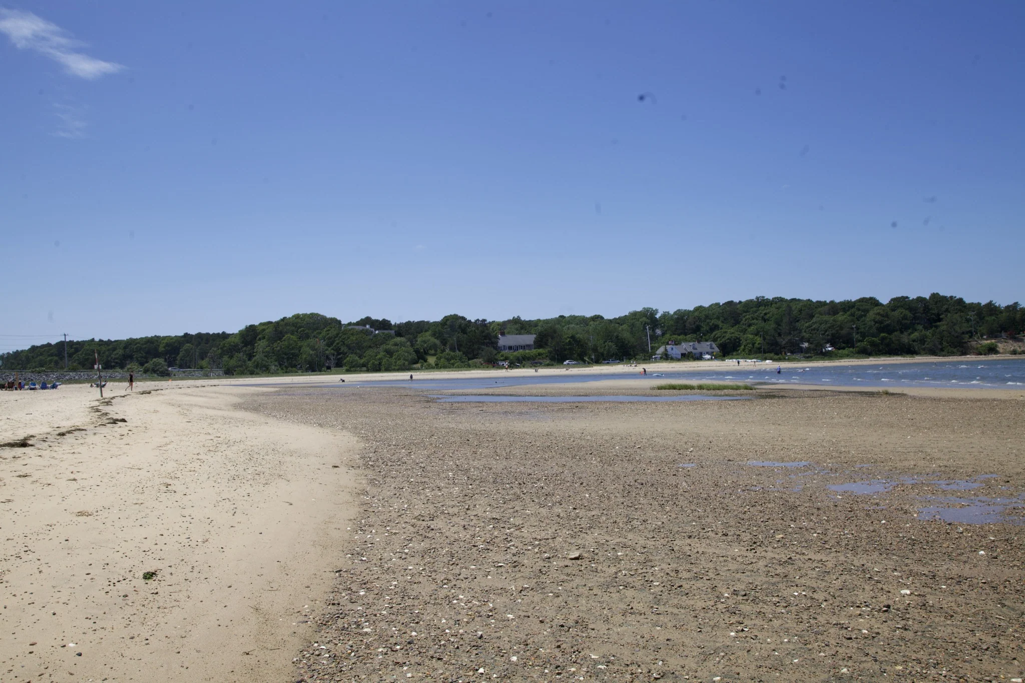 Broad sand spit curving into the tidal cove at low tide in Chatham, Massachusetts