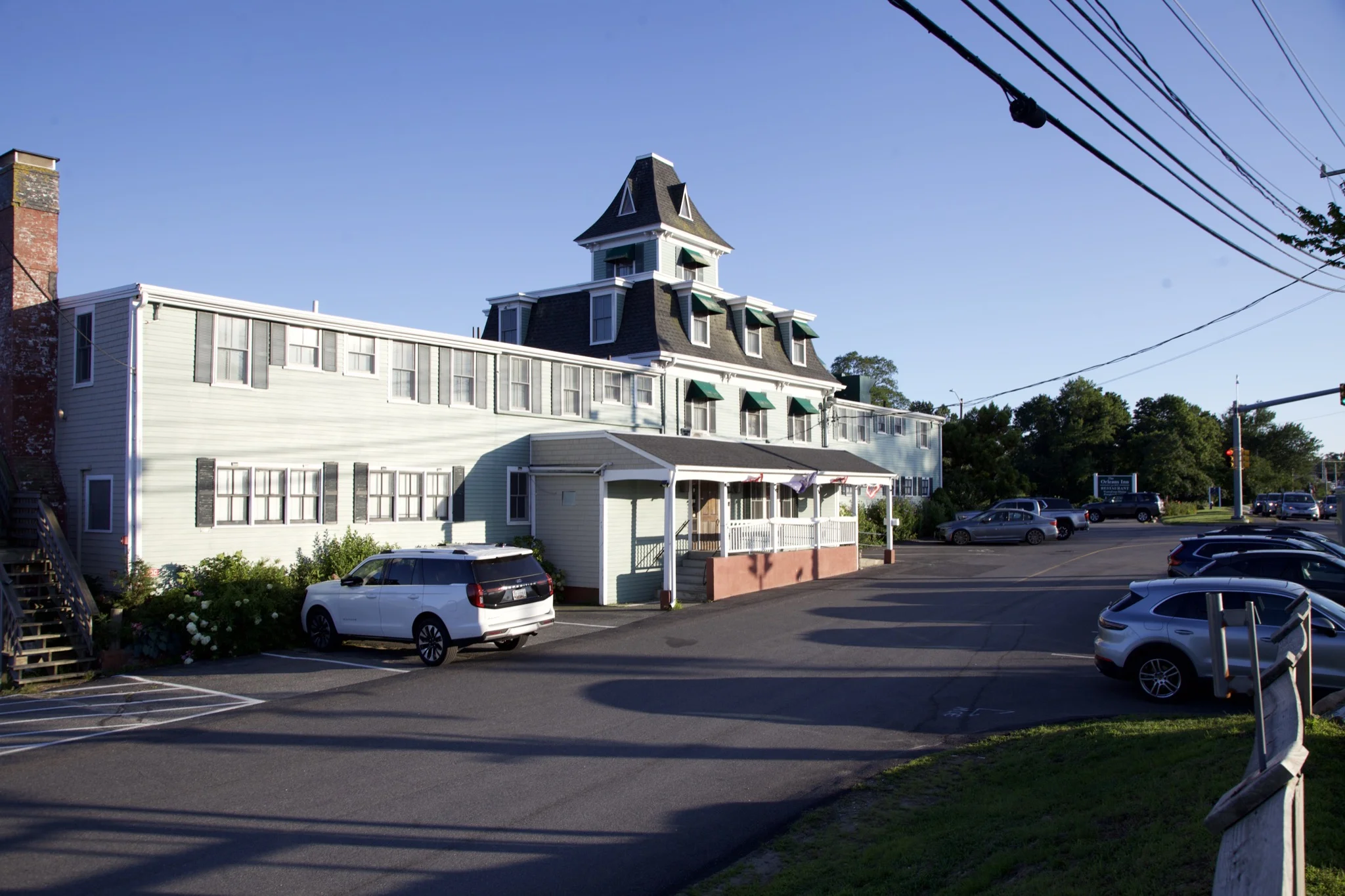 The Orleans Inn, a shingled mansard-roofed landmark overlooking Town Cove in Orleans, Massachusetts
