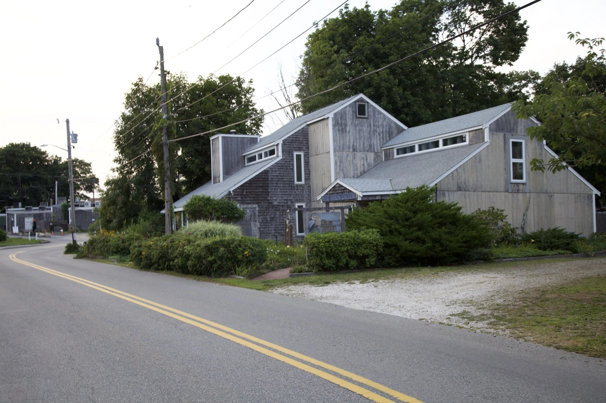 Weathered cedar-shingle building with white trim on a Wellfleet street corner